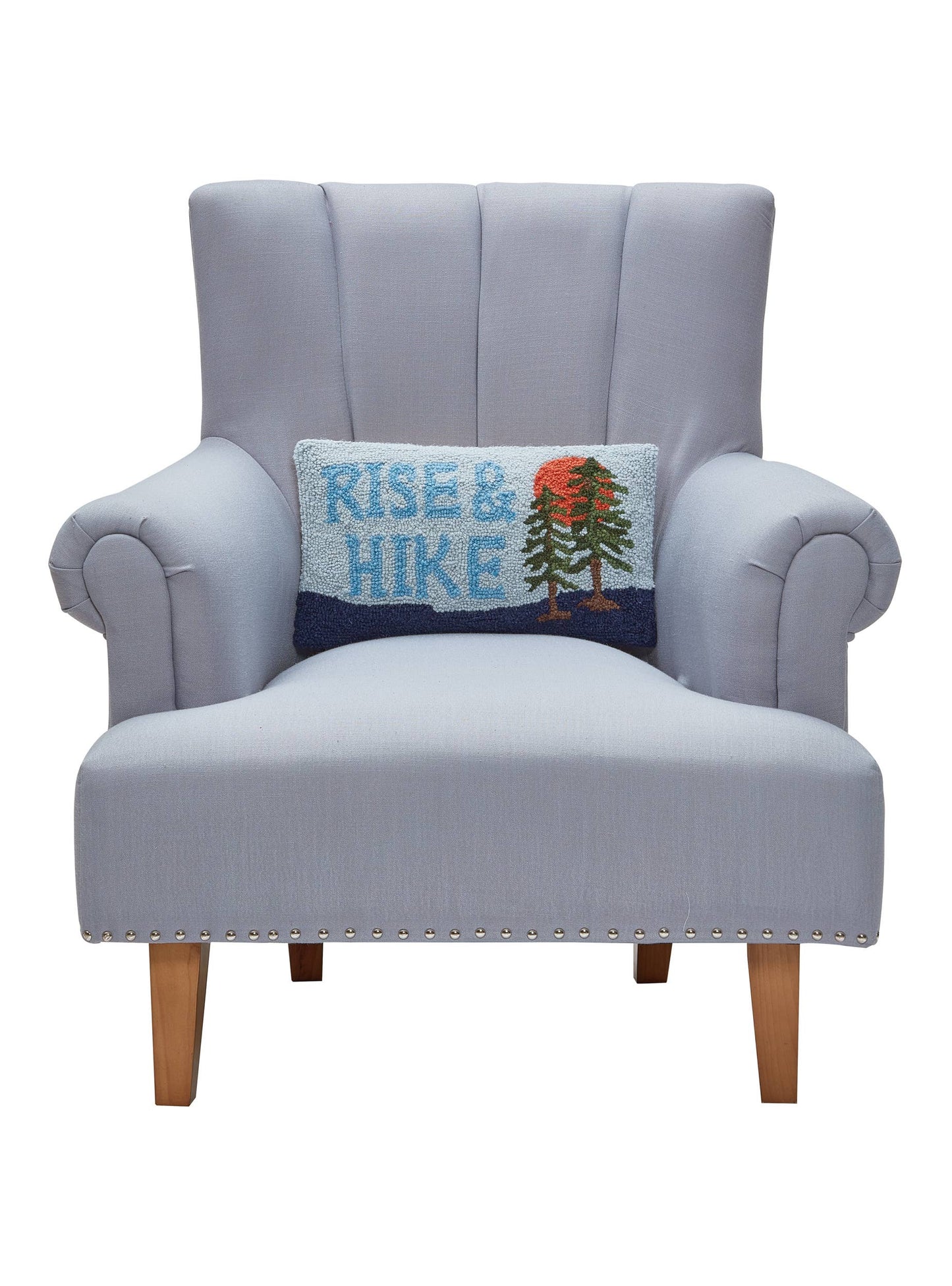 Gray armchair with a 'Rise & Hike' pillow on a white background