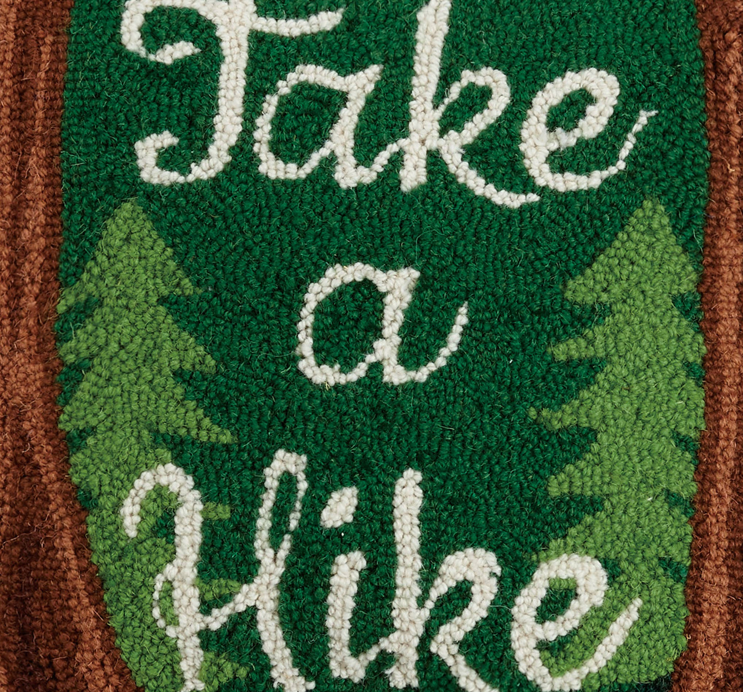 Text 'Take a Hike' on a green background with tree illustrations, framed by brown border.