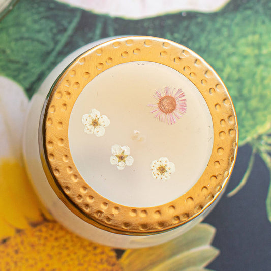 Cosmetic container with floral design on a decorative background