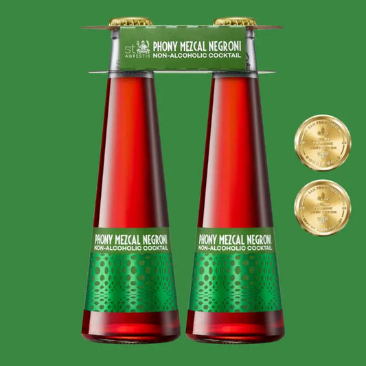 Two bottles of Phony Mezcal Negroni non-alcoholic cocktail with gold medals on a green background