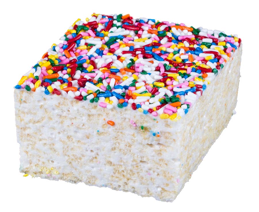 Square piece of cake with colorful sprinkles on a white background