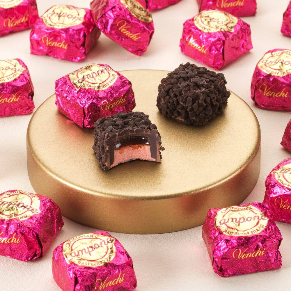 Vendi chocolate truffles with pink wrappers on a white background