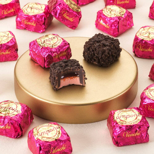Vendi chocolate truffles with pink wrappers on a white background
