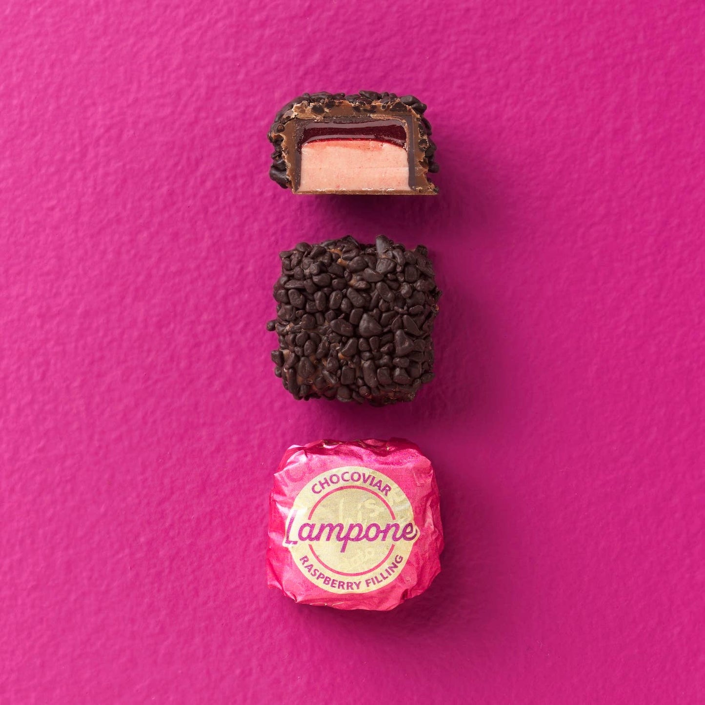 Chocolate truffle with pink candy on a pink background