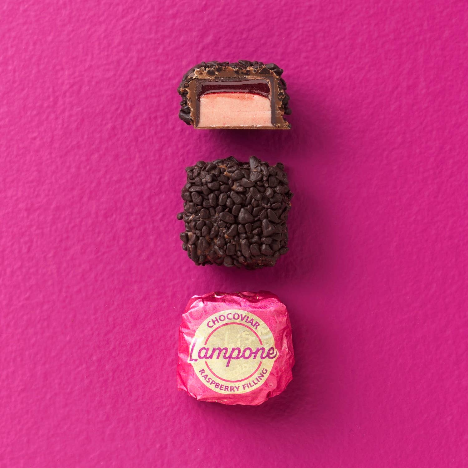 Chocolate truffle with pink candy on a pink background
