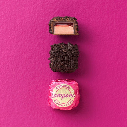 Chocolate truffle with pink candy on a pink background