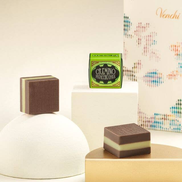 Chocolate dessert with a box of Cremino chocolate on a decorative background
