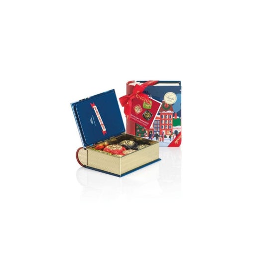Open book-shaped gift box with chocolates and a closed book on a white background