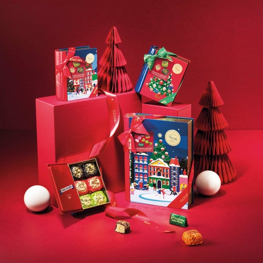 Christmas-themed gift boxes and decorations on a red background