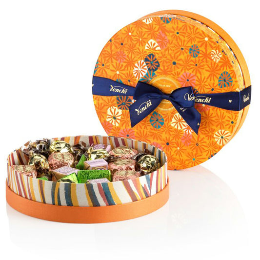 Decorative round candy box with colorful pattern and Venchi branding on a white background