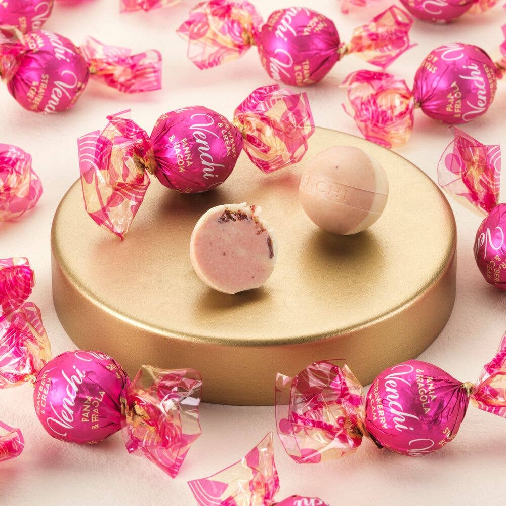 Pink candies with 'Venessi' packaging on a gold stand