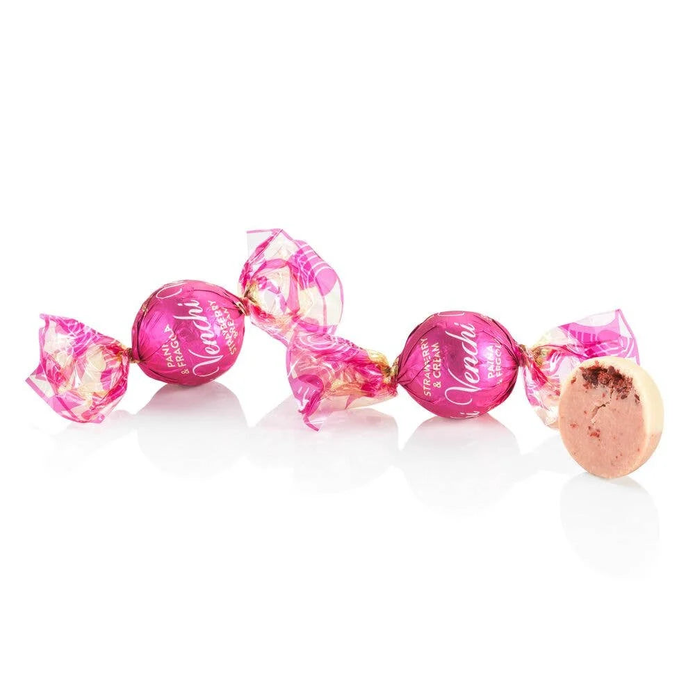 Pink and gold candies with 'Vanilla' text on a white background